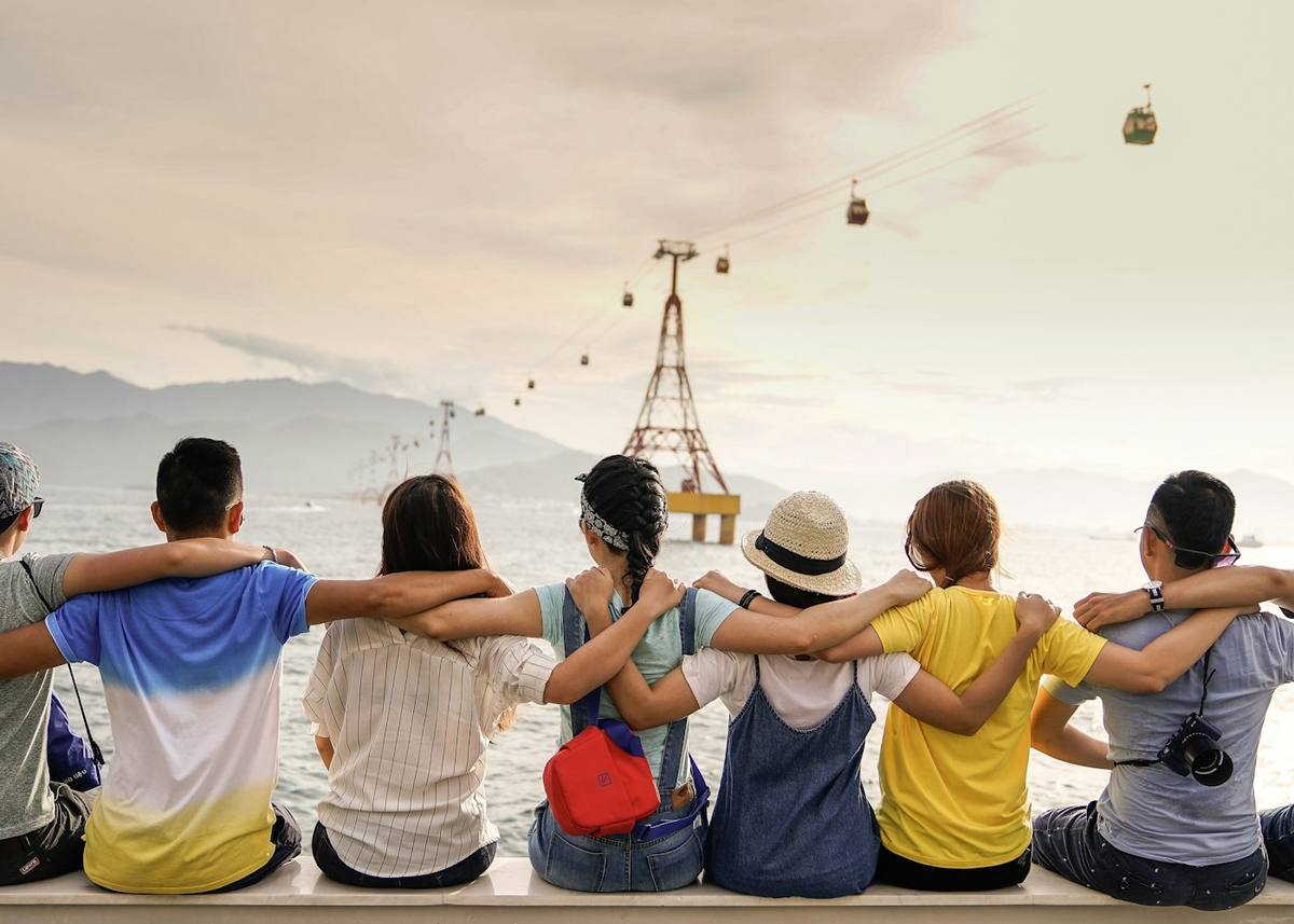 Friends sitting together with their arms around each other